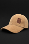 A tan corduroy baseball cap with a small brown embroidered patch on the front that reads 'LIVE MORE WORK LESS' in reverse, set against a solid black background.