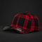 A structured baseball cap featuring a red and black plaid pattern, photographed on a dark studio background. The cap has a curved brim with a light gray underside and a visible New Era 9FIFTY sticker on the front.