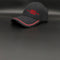 A black baseball cap with red embroidered text reading '1994 5 PLATINUM NUM LOVES' on the front, featuring a red accent line along the edge of the curved brim, set against a dark gray background.