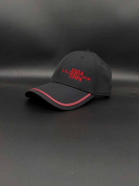 A black baseball cap with red embroidered text reading '1994 5 PLATINUM NUM LOVES' on the front, featuring a red accent line along the edge of the curved brim, set against a dark gray background.
