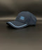 A dark navy blue Porto baseball cap with light blue embroidered text reading '1893 a vencer' on the front, resting on a dark gray surface.