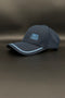 A dark navy blue Porto baseball cap with light blue embroidered text reading '1893 a vencer' on the front, resting on a dark gray surface.