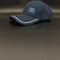 A dark navy blue Porto baseball cap with light blue embroidered text reading '1893 a vencer' on the front, resting on a dark gray surface.