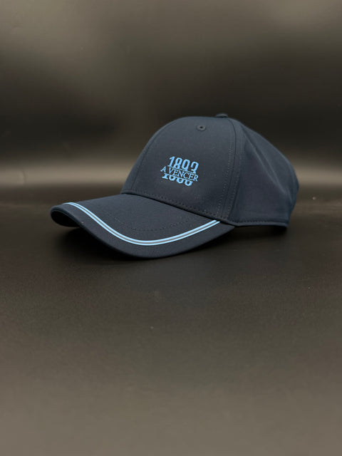 A dark navy blue Porto baseball cap with light blue embroidered text reading '1893 a vencer' on the front, resting on a dark gray surface.