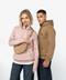A man and a woman modeling Fjälä hoodies and a matching tan crossbody bag against a clean white studio background. The woman wears a dusty pink hoodie, and the man wears a camel brown hoodie.