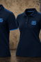 Two navy blue polo shirts displayed side by side against a textured brown and blue background. Both shirts feature light blue trim on the collar and sleeve cuffs, with a light blue embroidered '1899 A.