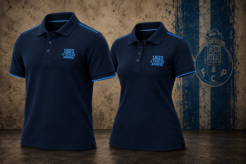 Two navy blue polo shirts displayed side by side against a textured brown and blue background. Both shirts feature light blue trim on the collar and sleeve cuffs, with a light blue embroidered '1899 A.